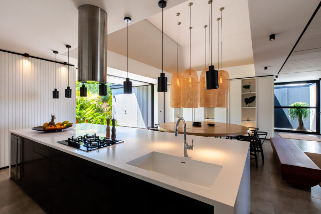 Villa Valentina, St. Barts: open kitchen island and round dining table in natural light.